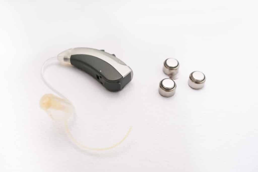 Hearing aid with hearing aid batteries on the table